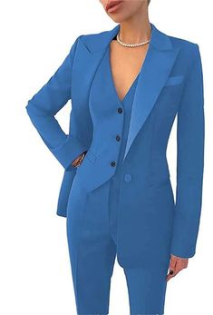 a woman in a blue suit posing for the camera