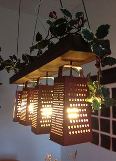 some lights are hanging from the ceiling in front of potted plants and other items