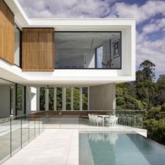 a large swimming pool in front of a modern house