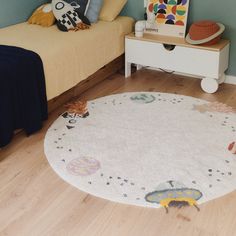 a child's bedroom with two beds and a rug