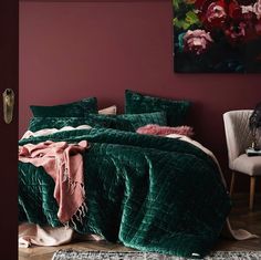 a bedroom with purple walls and green bedding, pink throw blanket on the bed