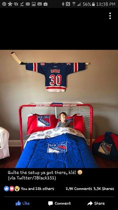 a young boy is laying in his bed with hockey jersey on the wall above him