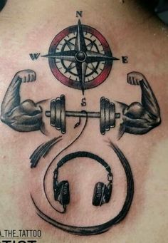 a man's back with headphones and a barbell tattoo on his chest