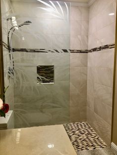 a walk in shower sitting next to a white sink