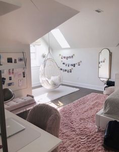 a bedroom with pink carpet and hanging chair