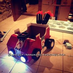 a homemade firetruck made out of cardboard and some kind of light up shoes