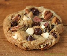 a chocolate chip cookie with nuts and other toppings