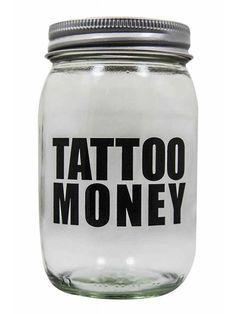 a glass jar with the words tattoo money on it's lid and an inscription in black