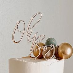 a white cake with gold and blue decorations on top that says ohp, do you?