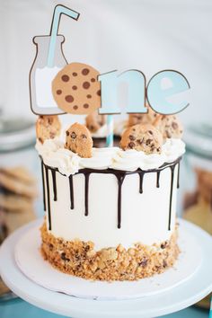 a birthday cake with cookies and milk on top