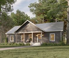 a small gray house in the middle of a field with trees and grass around it