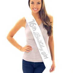 a beautiful young woman wearing a white sash with the words girl power written on it