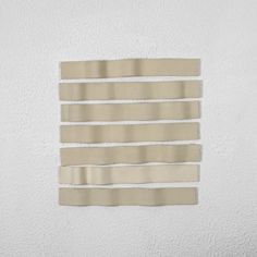 a piece of paper taped to the side of a wall with strips of tape on it