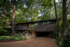 a large house surrounded by trees in the woods