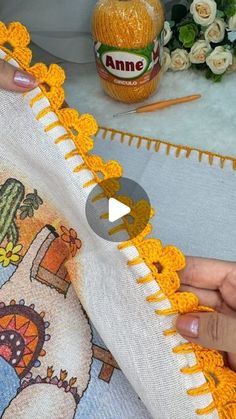 someone is crocheting the edges of a pillow