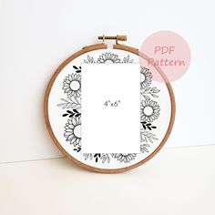 a cross stitch pattern with flowers on the front and back, in black and white