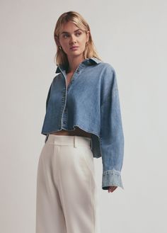 It's a fan favorite, now with slightly cropped styling. The Crop Ex-Boyfriend Shirt is an oversized button up cut from a lightweight cotton denim with a relaxed fit , tortoise buttons and pointed collar. With the shortened length, you'll find it's super versatile as an unbuttoned layer over The Ribbed Tank or buttoned up with absolutely anything. 100% CottonCare Instructions:Machine wash cold gentle cycleTumble dry lowMegan is 5'10" wearing size Small Collar Crop Top Outfit, Cropped Denim Shirt Outfit, Denim Crop Top Outfit, Cropped Button Up Shirt Outfit, Cropped Shirt Outfit, Boyfriend Shirt Outfits, Cropped Denim Shirt, Button Down Outfit, Denim Shirt Outfit