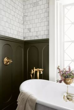 a white bath tub sitting next to a window