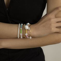 Step up your accessory game with the playful mix and match style of this bracelet set flaunting a variety of designs and pearl details for a glam look. Includes two beaded stretch bracelets, two color block beaded stretch bracelets and one pearl charm bracelet (five pieces total) Stretch bracelets: 4" diameter; 6.2" L Charm bracelet: 6.2" L with 1.9" extender Lobster claw clasp 18k gold-plated copper / pearl / howlite Lotus Bracelet, Pearl Charm Bracelet, Blue Howlite, Bracelet Sets, Feather Bracelet, Copper Pearl, Bohemian Summer, Hand Chain, Beaded Choker Necklace