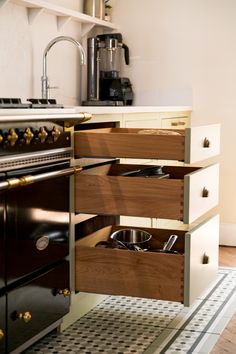 a kitchen with an oven, stove and counter top in the middle of it's cabinet space