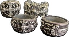 four silver rings with bows and diamonds on them