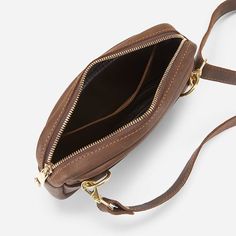 Experience the joy of versatility and style with our Desta Leather Belt Bag, inspired by the spirit of Ethiopia. Perfect for faraway adventures or your daily commute, it's the ultimate accessory for the modern traveler. This hands-free bag is back and more stylish than ever, outfitted in classic brown or black leather with premium brass detailing. Wear it around your waist throughout the day, or add one of our crossbody straps to transition into a night out. The Desta's main compartment is lined Modern Brown Belt Bag With Adjustable Strap, Brown Belt Bag With Detachable Strap For On-the-go, Brown Belt Bag With Gold-tone Hardware, Brown Belt Bag With Adjustable Strap For On-the-go, Leather Belt Bag With Gold-tone Hardware In Pouch Shape, Hands Free Bag, Classic Brown, Leather Belt Bag, Goat Leather