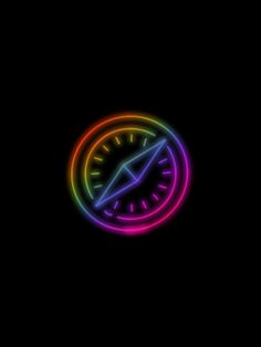 the clock is lit up in the dark with rainbow light on it's face