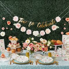 a table topped with plates and cakes covered in flowers