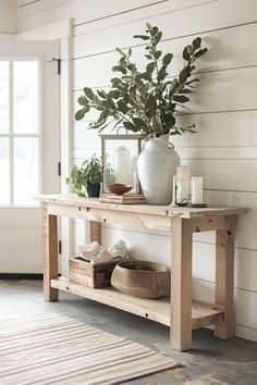 a wooden table topped with a potted plant next to a window