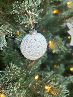 a crocheted ornament hanging from a christmas tree