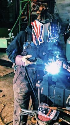 welder working on an item in a factory with sparks coming from the welding machine