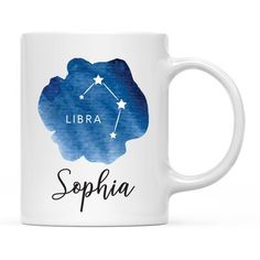 a white coffee mug with the name and zodiac sign, in blue watercolor on it