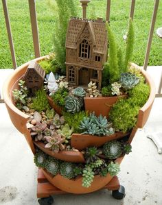 a potted planter filled with succulents and plants on a porch