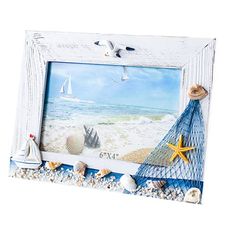 a photo frame with seashells and starfish on the beach next to it