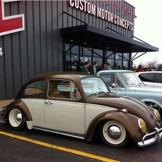 two old cars parked in front of a building