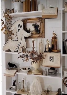 a book shelf filled with lots of books and decor on top of it's shelves