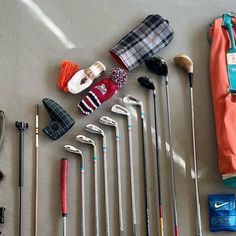 various golf accessories are laid out on the floor