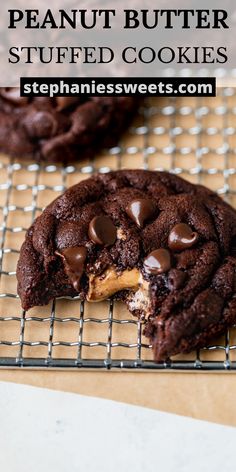 a chocolate peanut butter stuffed cookie is on a cooling rack and has one bite taken out