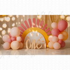 a table topped with balloons and a wooden sign that says one on top of it