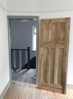 an empty room with two wooden doors in it