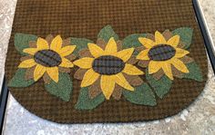 a close up of a rug with sunflowers on it