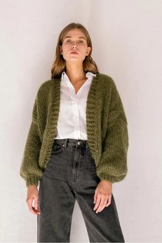 The Mohair Bomber Cardigan, a chunky open-front cardigan hand knitted in fluffy kid mohair that feels like being wrapped in a soft, puffy cloud. Designed to flatter all silhouettes with its wide oversized fit, slightly cropped length and voluminous balloon sleeves. Comes in a range of neutrals, carefully chosen to match all wardrobe color palettes. Super soft, premium quality Italian mohair Composition: 60% kid mohair, 40% microfiber Hand wash in cold water Handcrafted in Greece Size & Fit Wide Handmade Mohair Cozy Cardigan, Green Mohair Winter Cardigan, Hand Knitted Mohair Cardigan, Hand Knitted Mohair Outerwear, Cozy Hand Knitted Mohair Cardigan, Hand Knitted Mohair Cardigan For Winter, Cozy Mohair Knitted Cardigan, Cozy Knitted Mohair Cardigan, Cozy Fall Mohair Knitting Pattern