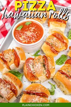 mini pizzas with marinara sauce and basil leaves on a baking sheet, ready to be eaten