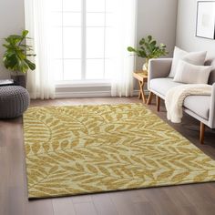 a living room with a couch, chair and rug on the hardwood floor next to a window