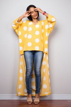 "Yellow Boho Kaftan top | Cotton Tunic top | polka dot beachwear tunic | Short front poncho top dress | blouse top | poncho top, beach cover up, summer tunic dress Produced by NUICHAN PRODUCT SIZE : One Size Fits Most These are the exact measurements from the dress, measured whilst laying flat >> * Chest : up to 52\" * Waist : 50\" * Sleeve length from neckline to hem : 21\" * Length (front part) : 24.5\" * Length (back) 52\" NOTE : * Model chest : 32\", waist : 24\" hips : 35\" * Combined Polka Dot Long Sleeve Beach Dress, Long Sleeve Polka Dot Beach Dress, Beach Long Sleeve Polka Dot Dress, Polka Dot Blouse For Summer Day Out, Polka Dot Blouse For Day Out In Summer, Polka Dot Blouse For A Summer Day Out, Polka Dot Tops For Summer Beach Days, Polka Dot Tops For Beach In Summer, V-neck Polka Dot Blouse For Summer