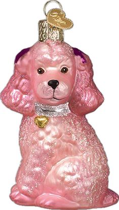 a pink dog ornament with a gold bell on it's head