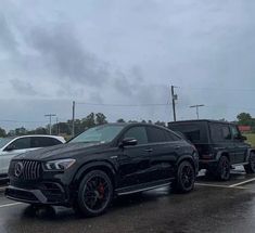 two cars parked in a parking lot on a rainy day