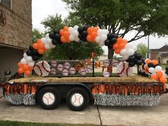 an orange and black baseball themed party float