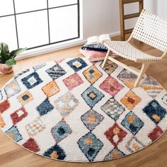 a white rug with multicolored squares on it and a chair next to it