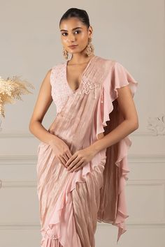 Peach pre-draped ruffle trim saree with placement embroidery work. Paired with a floral butti embroidered blouse. - Aza Fashions Sleeveless Silk Blouse With Ruffles, Draped Blouse With Ruffles, Elegant Traditional Drape Summer Blouse, Sleeveless Ruffled Blouse For Wedding, Silk Saree With Ruffles, Silk Blouse With Ruffles In Traditional Drape, Silk Blouse With Ruffles And Traditional Drape, Festive Sleeveless Saree With Ruffles, Elegant Draped Blouse Piece With Ruffles